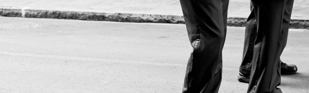 two business men in suits next to a sidewalk; highlighting the question of how to incorporate a business