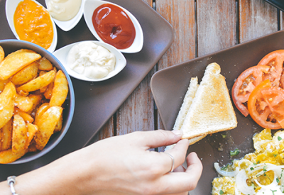 Top view of three plates with food; highlighting tax preparation for meal expenses