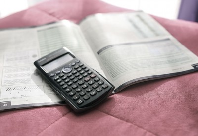 Graphing caulcuator and book, highlighting mistakes on tax returns